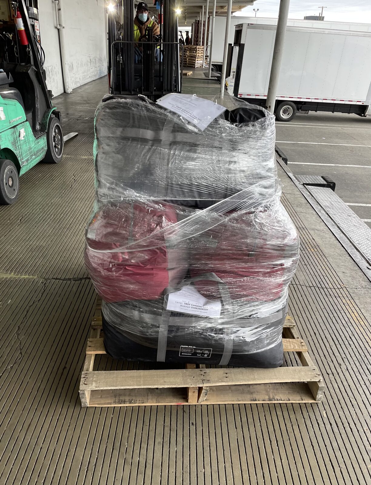 A wrapped pallet of Woolly Wishes donations on a forklift at the cargo terminal